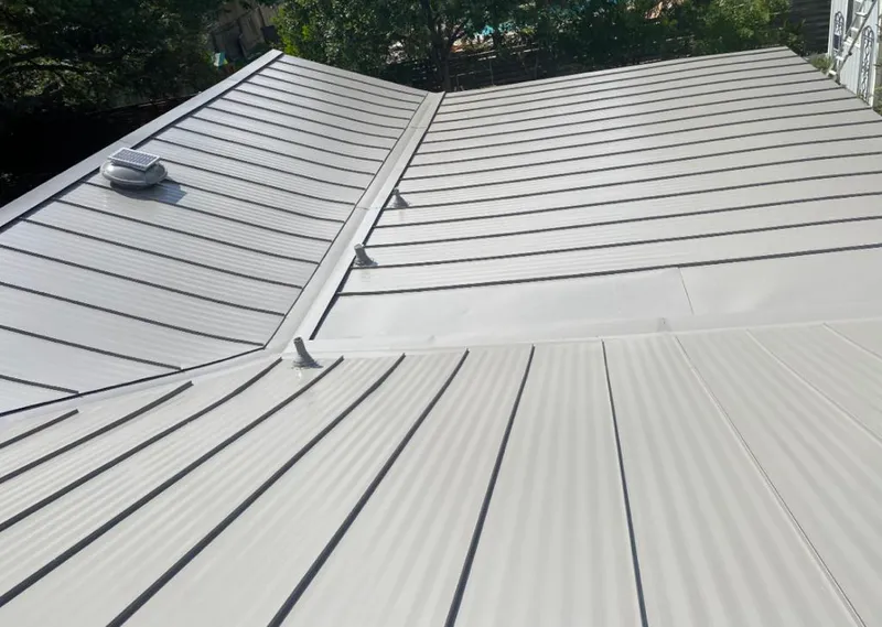 Solar attic fan installed on a metal roof for Roof Ventilation in Matawan